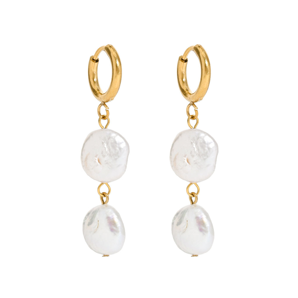 A pair of gold hoop drop earrings with irregular white baroque pearls hanging from gold rings, shown against a plain white background.